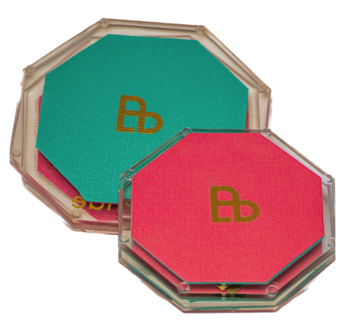 Two Bellenae spinning boards, a larger one with a teal mat behind a smaller one with a coral mat